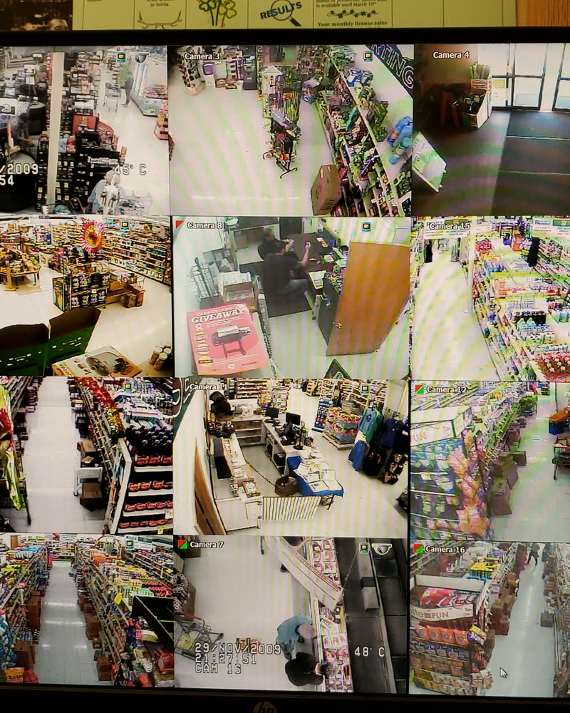 A wall of sixteen live camera feeds at a Mac's Tech retail install