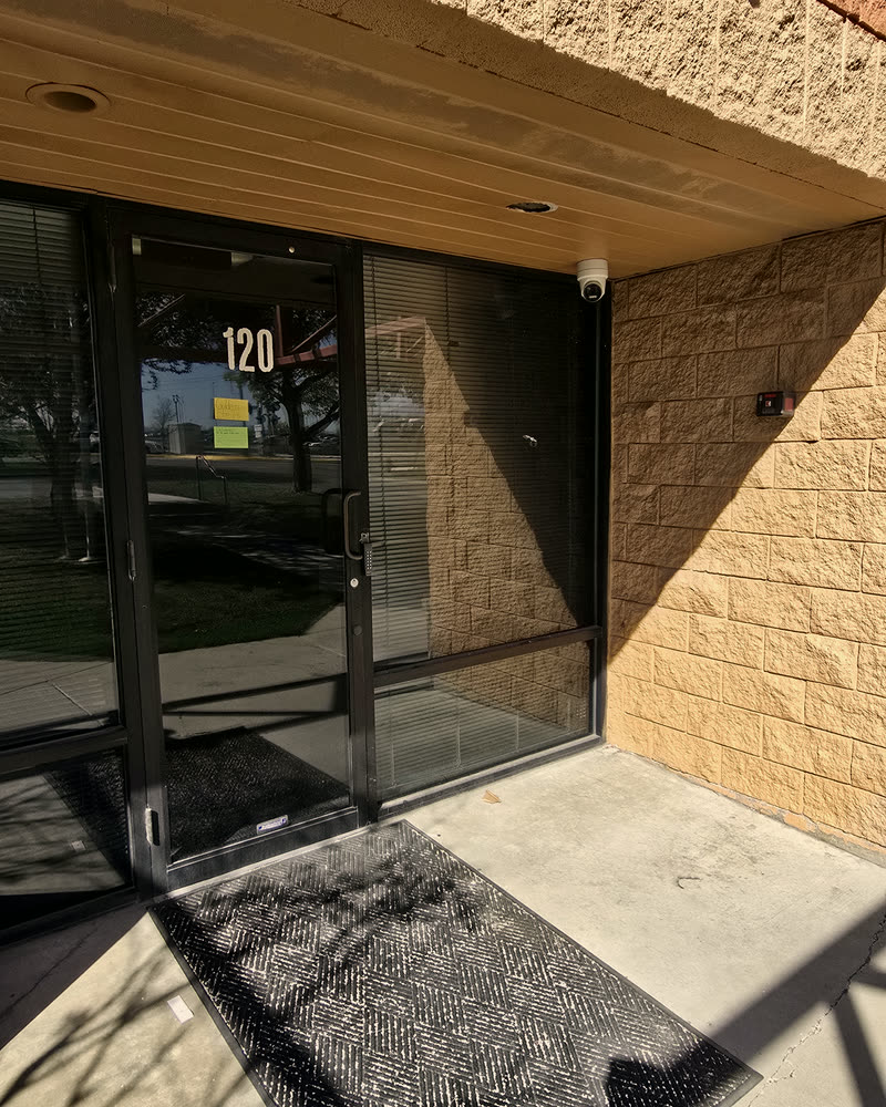 Office entrance with a mounted camera and access control reader
